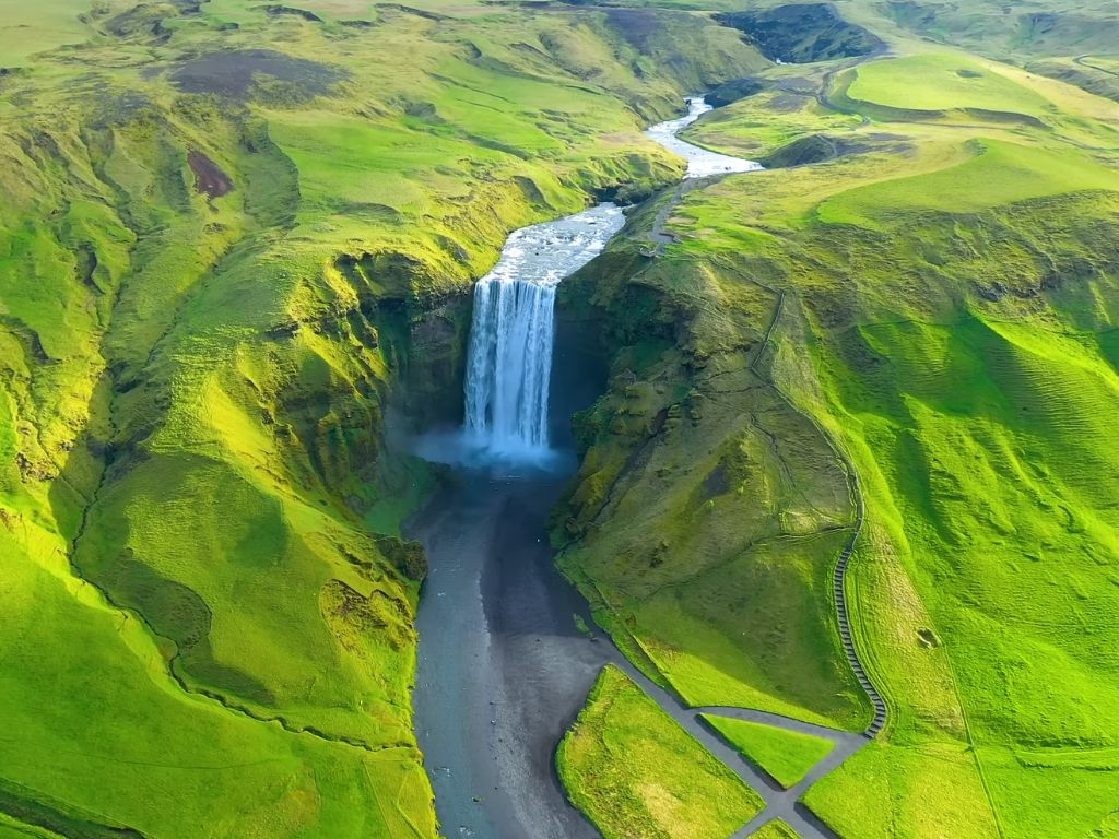 iceland green landscape and waterfall